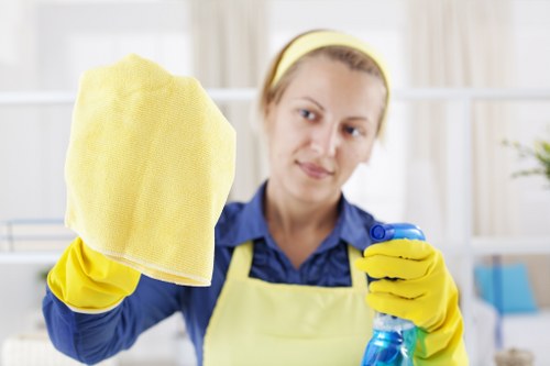 Trained cleaner using protective gloves and mask during carpet cleaning