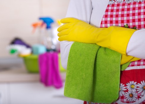 Cleaner working on a carpeted area during a service visit